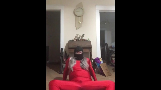 Trans in Red Spandex Teases with Resistance Band